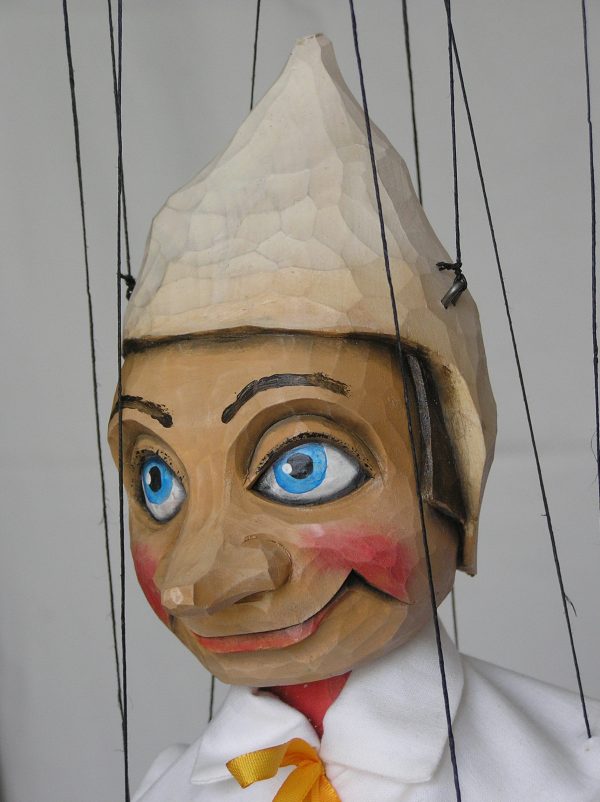 Head of puppet Pinocchio with wooden white hat